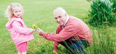Picture of an older man and his granddaughter in a field
