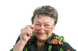 portrait of an old smiling woman wearing glasses