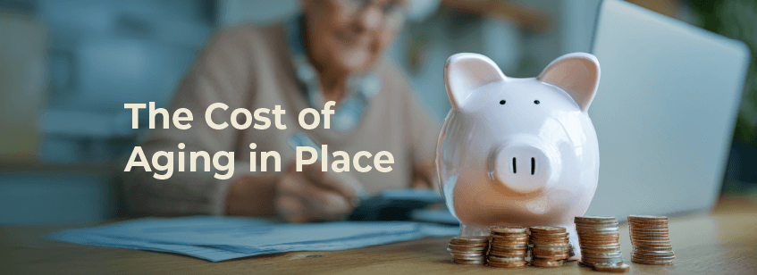 In the blurred background, a Caucasian white lady with glasses and curly white hair sits at a laptop. In the foreground, a white porcelain piggy bank looks directly at the camera, surrounded by five stacks of various American coins.